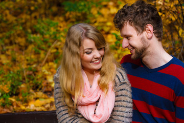 Fototapeta premium Lovers couple in autumn park on bench