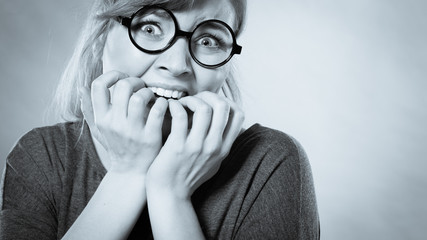 Nervous girl biting nails.