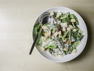 Caesar salad on wood table