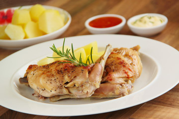 Roasted rabbit, boiled potatoes and rosemary herb. Close up view.