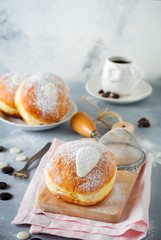Fresh baked berliner with custard on a gray concrete background. German donats. Selective focus.Top view.