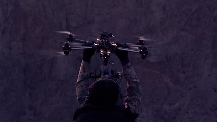 Operators of the Research UAV. The drone slowly descends into the hands of the orator after a night exploratory flight - Powered by Adobe