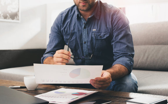 Man analyzing financial reports at the office
