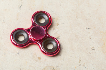 fidget SPINNER stress relieving toy on stone background