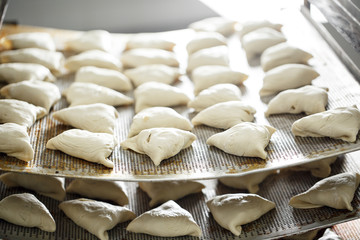 billet bun of dough with filling inside. Prepared for baking in baking production.