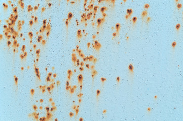 Metal gate painted with blue paint with rust