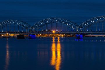 Obraz na płótnie Canvas Railway bridge at night in Riga, Latvia