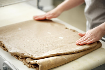the Baker rolls rye puff pastry on special equipment. selective focus