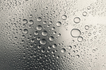 Water drops on silvery surface, background	