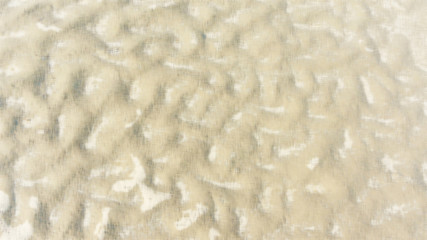 Light brown wavy background. Sand color art wallpaper.