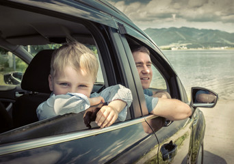 Father and son sitting in car