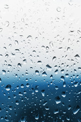 Raindrops on a glass, blue background
