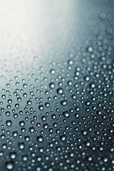 Water drops on rough surface, blue background	