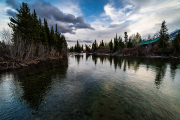 Grand Teton National Park with a Cabin near the stream running from Jenny Lake