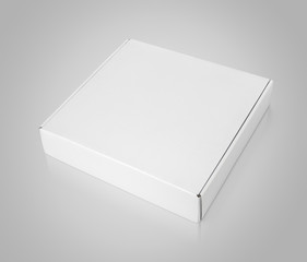 Closed blank square carton pizza box on gray background with clipping path