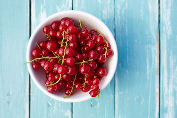 Top view of a red currant on a wooden table