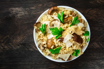 Overhead photo of mushroom risotto on rustic texture © laplateresca