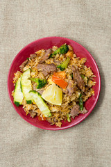 Homemade Chinese fried rice with vegetables and fried eggs