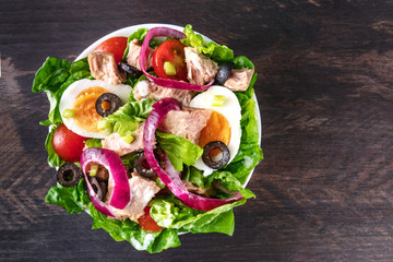 Colorful tuna salad on rustic texture with copyspace