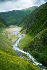 Fototapeta na wymiar Green caucassian valley and river seen from the above