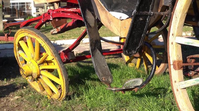 4K Old original carriage without horses and a child on it