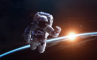 Obraz na płótnie Canvas Astronaut above the Earth. Science fiction space wallpaper, incredibly beautiful planets, galaxies, dark and cold beauty of endless universe. Elements of this image furnished by NASA