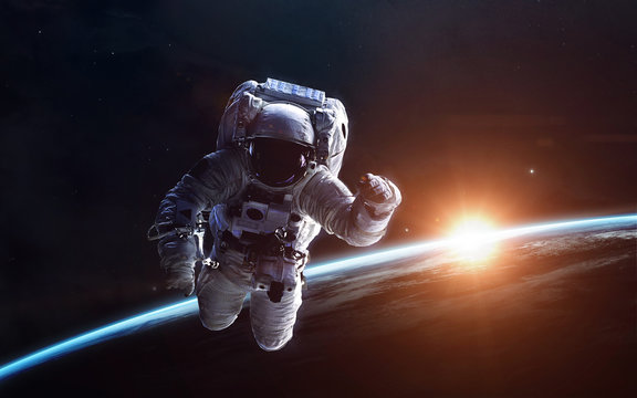 Astronaut above the Earth. Science fiction space wallpaper, incredibly beautiful planets, galaxies, dark and cold beauty of endless universe. Elements of this image furnished by NASA
