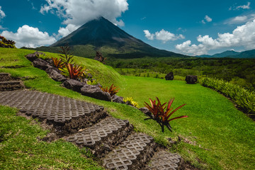 Volcano of Arenal with stone stairs on the foreground at sunny day. Costa Rica