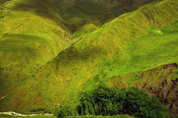 Green mountain slopes in different shades of the sun