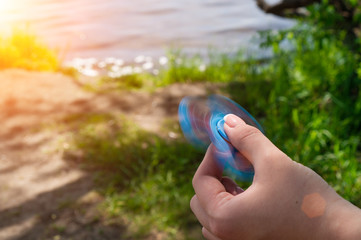man hand holding a spinner toy