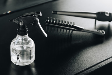 close up view of several hair styling supplies on table