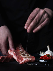 A Cook Preparing Ribs in the Kitchen
