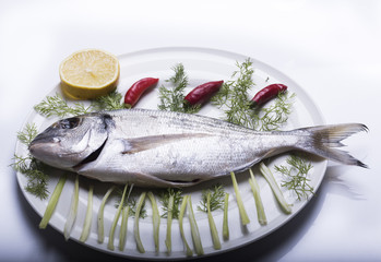 bream topped on a white plate ready to be cooked