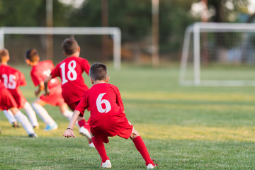 Obraz premium Kids soccer football - children players exercising before match on soccer field