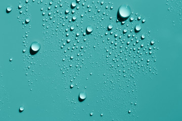Water drops on smooth surface, blue green background