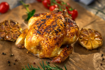 Roasted whole chicken on backing paper