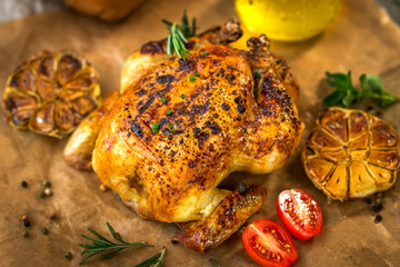 Roasted whole chicken on backing paper