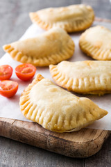 Typical Spanish empanadas on wooden table
