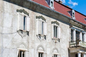 Old brick house with windows and balcony