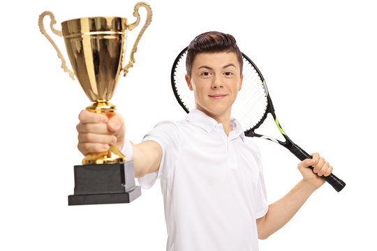 Teenage tennis player holding a golden trophy