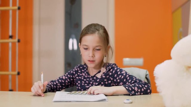 A girl of 8 years of age studies at home on mental arithmetic