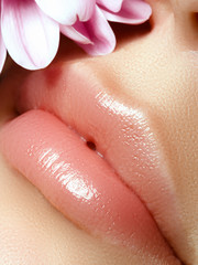 Fototapeta premium Lips augmentation. Perfect natural lip makeup. Close up macro photo with beautiful female mouth. Plump full lips. Close-up face detail. Perfect clean skin, light fresh lip make-up