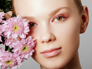 Aesthetic Cosmetology. Spring Woman. Beauty Summer model girl with colorful flowers . Beautiful Lady with Blooming flowers. Holiday Fashion Makeup.