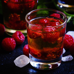 Cocktail with whiskey and raspberries, selective focus