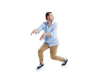 young scared man sneaking and looking away isolated on white