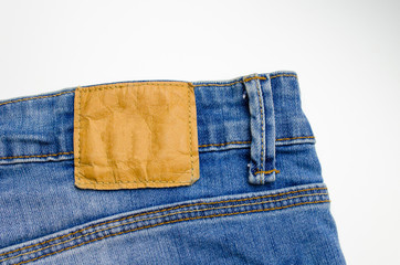 close up view of back pocket vintage blue denim jeans pant fashion, texture background isolated on white background, selective focus