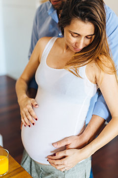 Couple at home, pregnant woman and husband
