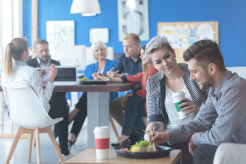 Pair of employees eating lunch