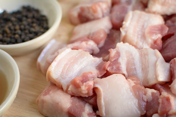 Raw pork on a cutting board wood table background