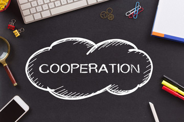 COOPERATION written on Chalkboard